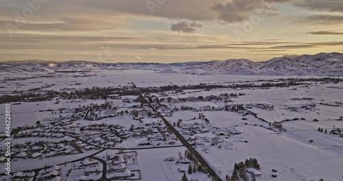 Oakley Utah Aerial v3 panoramic panning view drone flyover town area blanketed in a vast expanse of glistening snowfields and pristine mountainscape at sunset - Shot with Mavic 3 Cine - February 2023 photo