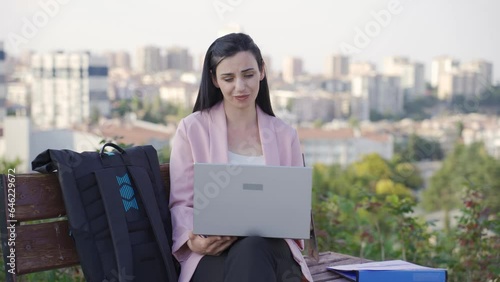 Businesswoman chatting online face to face with her girlfriend in the park. photo