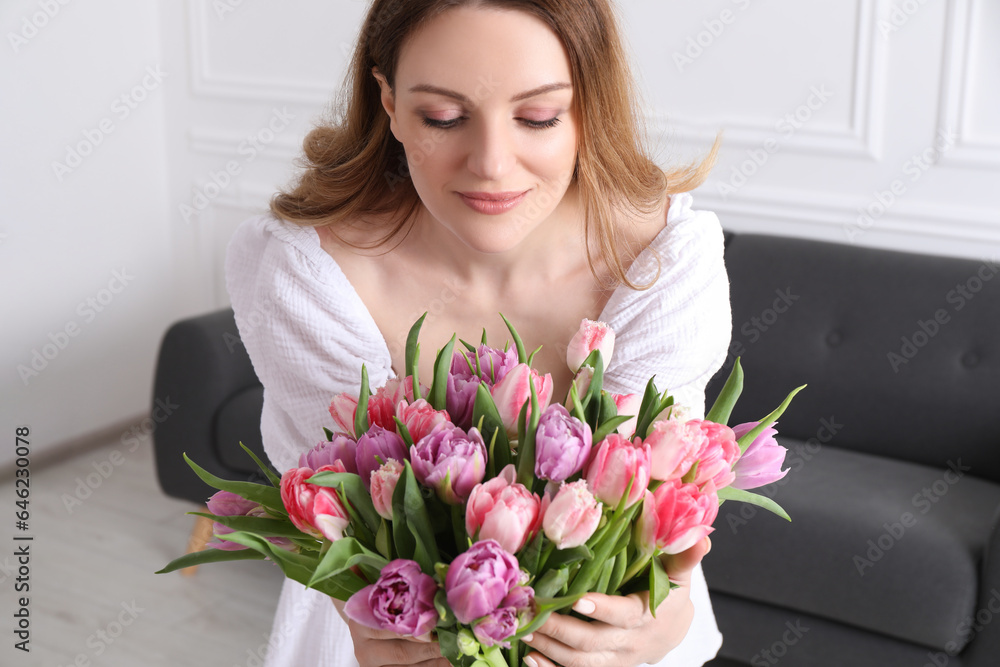 Young woman with bouquet of beautiful tulips indoors Young woman with bouquet of beautiful tulips indoors