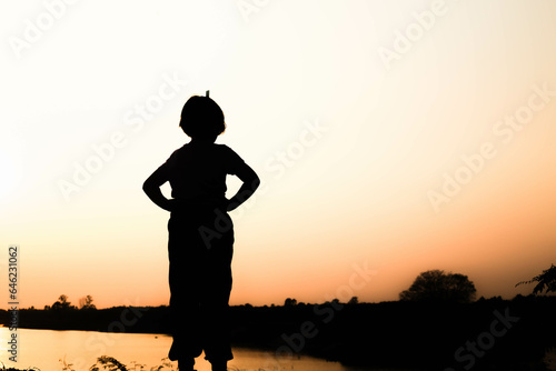Silhouette of a family comprising a father, mother and two children happy family the sunset.Concept of friendly  © Janpen