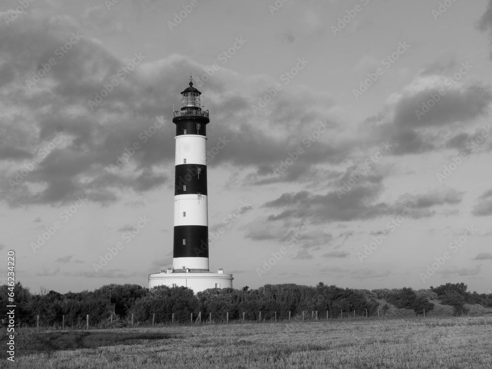 Chassiron black and white lighthouse at sunset