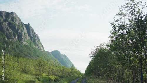 Road And Mountains Near Grunnfarnes Hamlet In Torsken, Norway. Wide Shot  photo