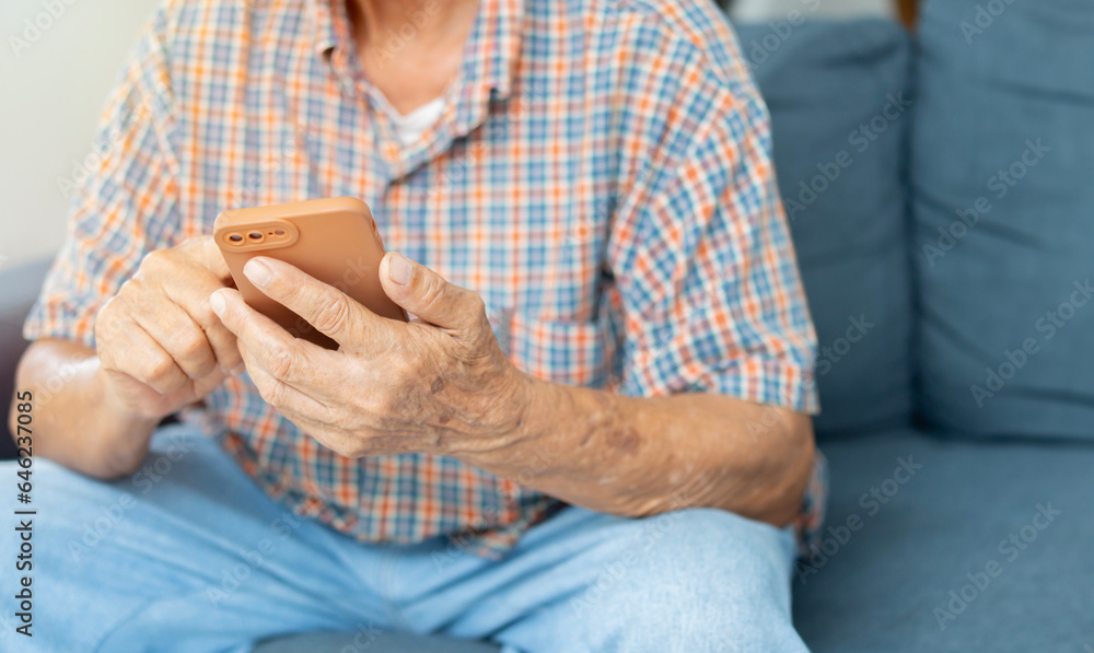 Cropped image of hands of older man holding a smart phone. Modern wireless technology easy usage of older