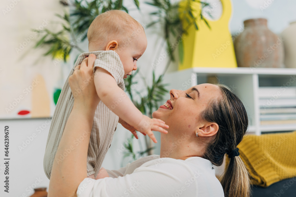 Side view of a beautiful Caucasian mother holding her baby.