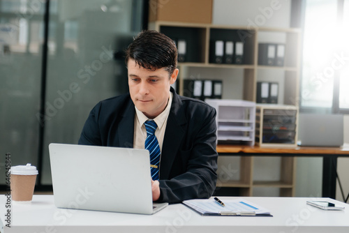 Mature business man executive manager looking at laptop watching online webinar training or having virtual meeting video conference doing market research working