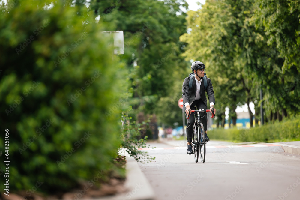 Fototapeta premium Manager commuting to the office by bike