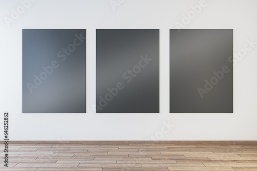 Modern gallery interior with empty black mock up posters on concrete wall and wooden flooring. 3D Rendering.