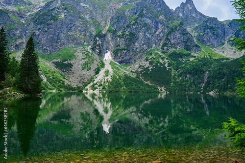 Amazing view on mountains range near beautiful lake at summer day. Tatra National Park in Poland. Panoramic view on Morskie Oko or Sea Eye lake in Five lakes valley