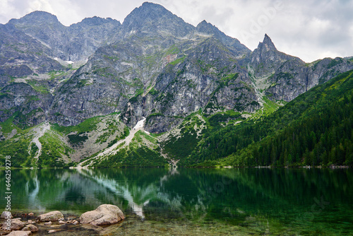 Amazing view on mountains range near beautiful lake at summer day. Tatra National Park in Poland. Panoramic view on Morskie Oko or Sea Eye lake in Five lakes valley
