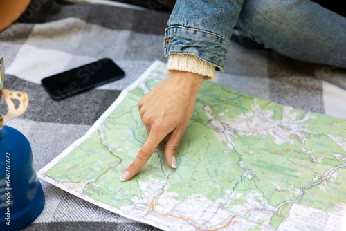 Close up picture of a female hand poing to the map