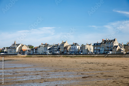 View of coastal street of Grandcamp Maisy, a scenic French coastal town in Normandy, with fishing port, sandy beaches, and maritime traditions.