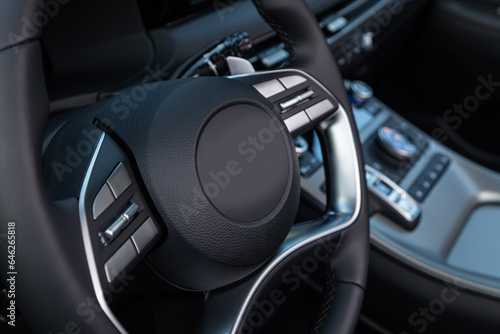  car Interior - steering wheel, shift lever and dashboard, display. Salon of a new stylish car.