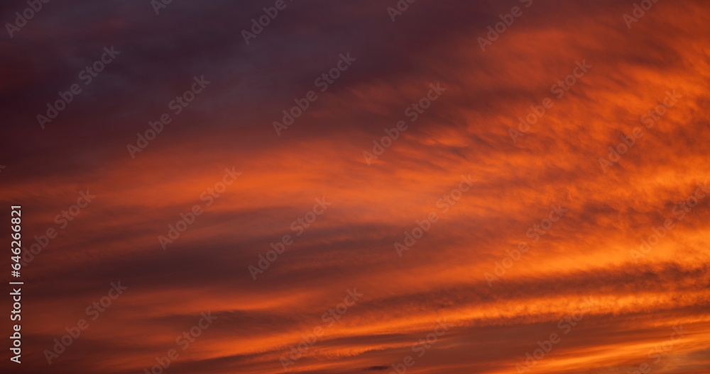 Sunset sky with orange clouds. Nature background.