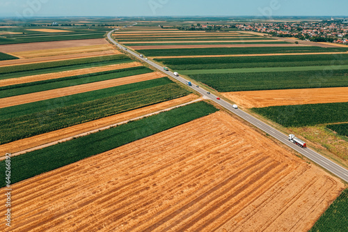 Aerial view of traffic on the highway through cultivated landscape in summer © Bits and Splits