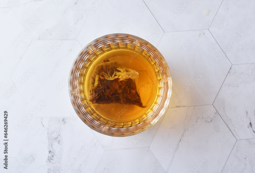 premium hot brew organic chinese green western black tea leaf bag hand pour in whisky glass pot and cup on luxury white marble table halal food beverage cafe drink menu design premium hot brew organic chinese green western black tea leaf bag hand pour in whisky glass pot and cup on luxury white marble table halal food beverage cafe drink menu design