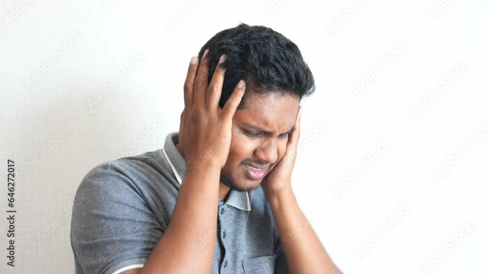 young man having ear pain touching his painful ear , young man having ear pain touching his painful ear ,