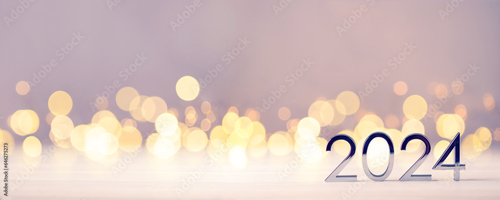 Metal numbers 2024 on a white table with Christmas trees and bokeh lights. Happy New Year 2024 is coming concept. - obrazy, fototapety, plakaty 