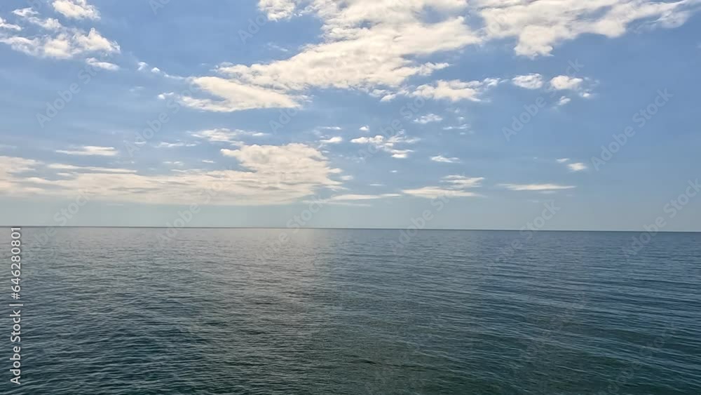 Sea water surface. Aerial view on calm water surface, camera flies over clear sea ocean. Sun glare. Abstract nautical summer ocean nature. Holiday and travel. Weather and climate change. Slow motion Sea water surface. Aerial view on calm water surface, camera flies over clear sea ocean. Sun glare. Abstract nautical summer ocean nature. Holiday and travel. Weather and climate change. Slow motion