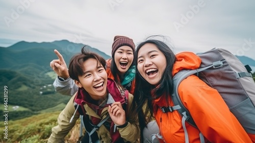 Gather of companions taking selfie on nation climb Youthful individuals climbing in farmland and taking pictures with savvy phone