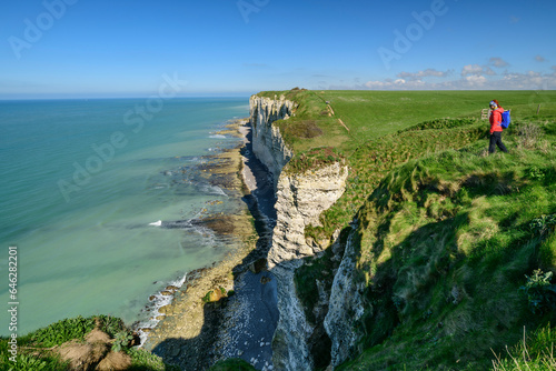 Mature woman walking on chalk cliff near sea photo