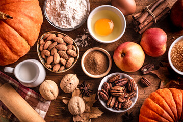 Autumn baking background with pumpkins, apples and nuts