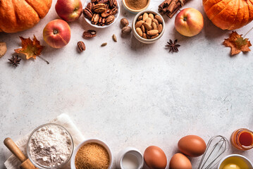 Autumn baking background with pumpkins, apples and nuts