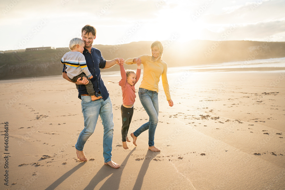 Cheerful father and mother enjoying with children at beach Cheerful father and mother enjoying with children at beach