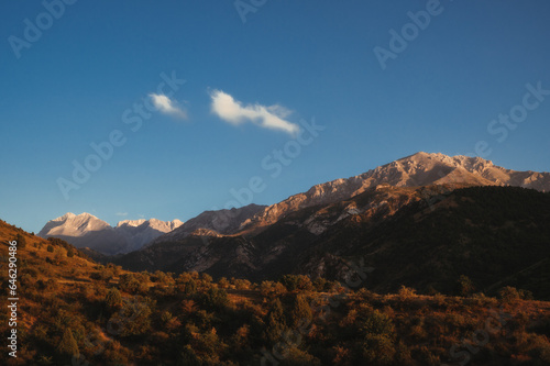 landscape with mountain peaks background the sky with clouds at sunset in autumn