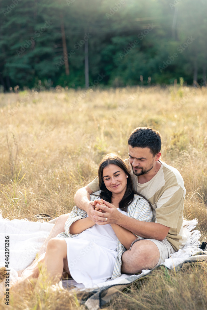 Happy married man and woman on a date relaxing in the field. Happy married man and woman on a date relaxing in the field.