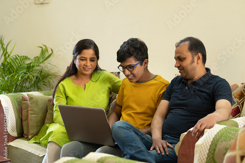 parents sitting with their child on sofa