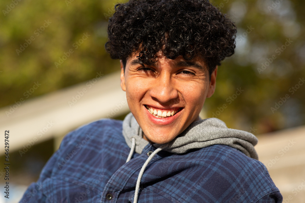 Close up smiling young man with curly hair