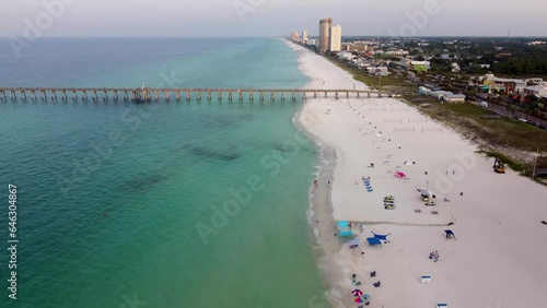 Panama city beach fishing pier and beach aerial coastal view with empty beach on early morning. Gulf of Mexico Aerial view during morning dawn, clear water beach of Panhandle Florida America. photo