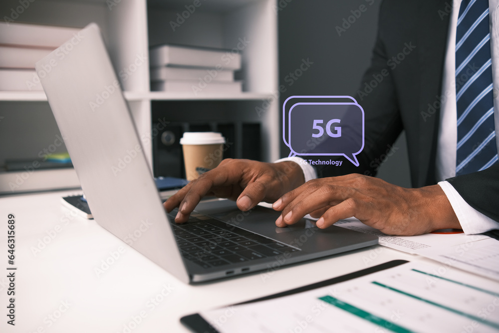 5G network theme with person using a laptop computer 5G network theme with person using a laptop computer