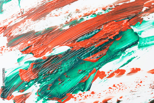 Acrylic paint blot, chaotic brushstroke, spot flowing on white paper background. Creative green orange color backdrop, fluid art.