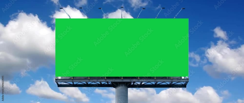 Wide blank green billboard or large display and moving white clouds against blue sky. It's feel like consumerism, time lapse, advertising, template, mock up, copy space and chroma key concept. Wide blank green billboard or large display and moving white clouds against blue sky. It's feel like consumerism, time lapse, advertising, template, mock up, copy space and chroma key concept.