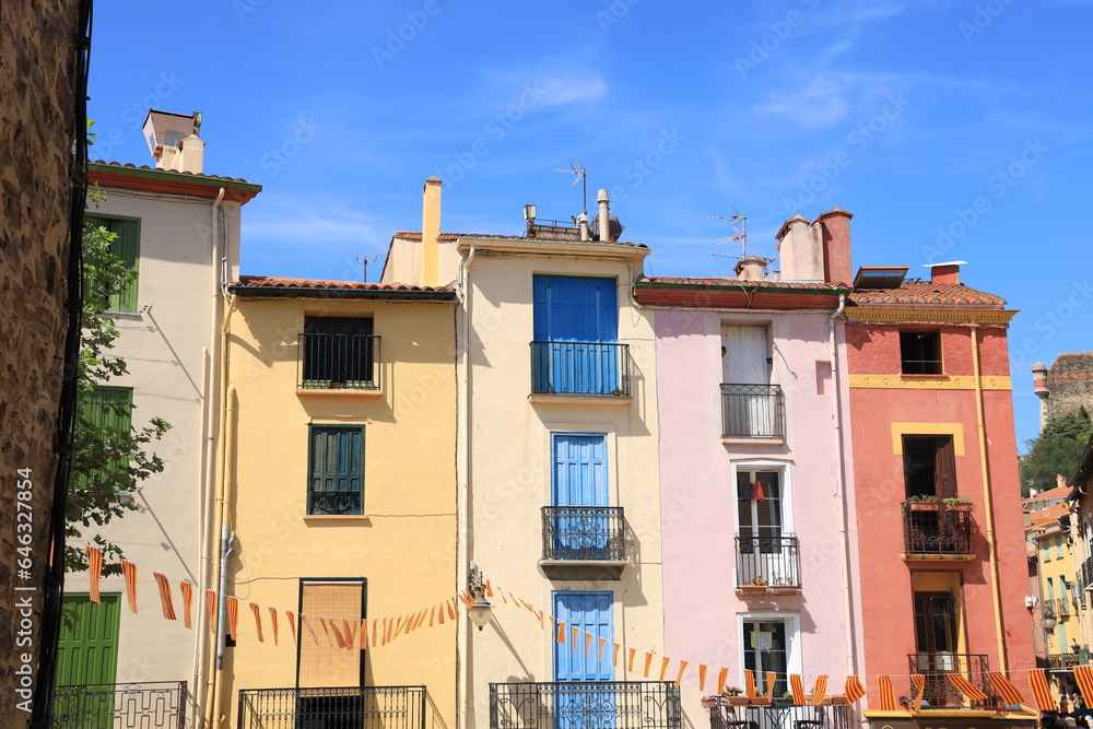 Colourful house fronts against backdrop of blue sky in Collioure, a Mediterranean seaside town in south of France