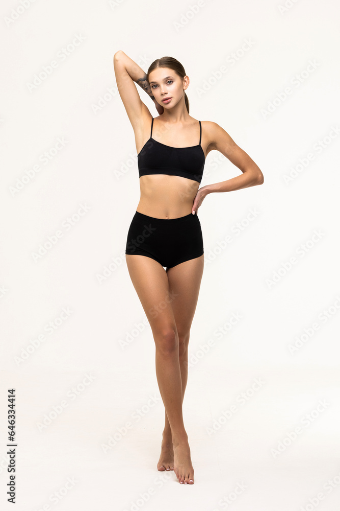 Sexy young woman in black panties checking cellulite on her legs hip. Sexy young woman in black panties checking cellulite on her legs hip.