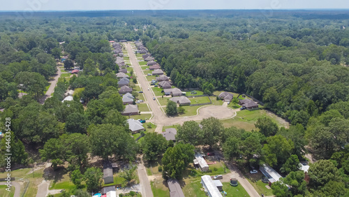 New development single family houses near row of manufactured, modular, and mobile homes in Richland, Rankin County, Mississippi suburb Jackson, USA lush green trees photo