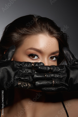 Fashion Woman in black gloves, portrait. Long hair, beauty beautiful eyes