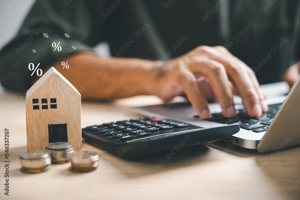 Pressing calculators, hand plans home refinance. House model, buy or rent, calculators on desk. Saving for property purchase, optimal mortgage payment. Tax, credit analysis for financial planning. - obrazy, fototapety, plakaty 