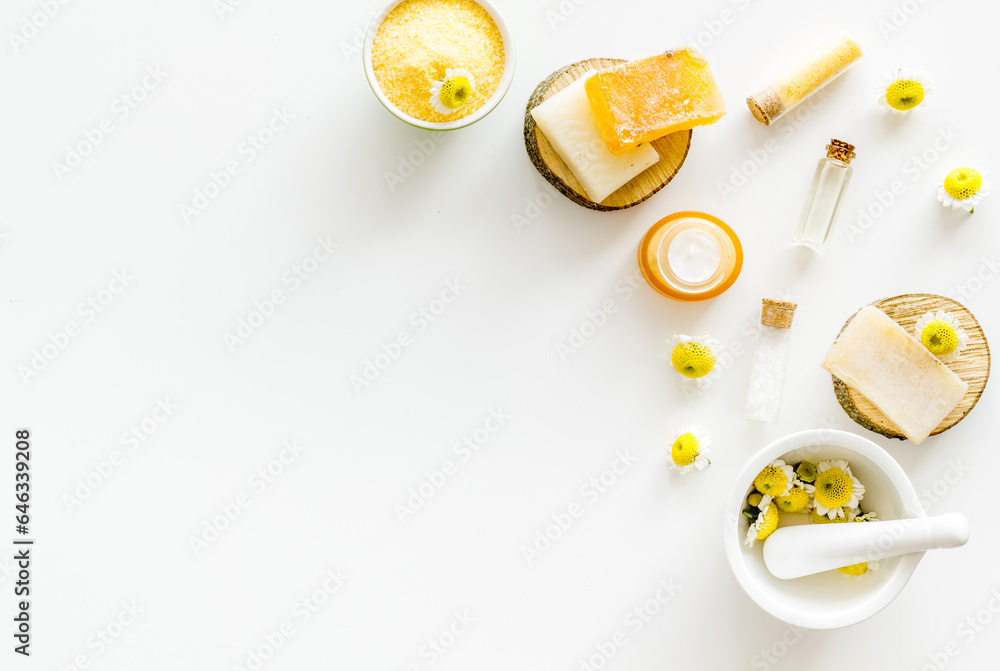 Herbal organic cosmetics products with chamomile flowers, top view Herbal organic cosmetics products with chamomile flowers, top view