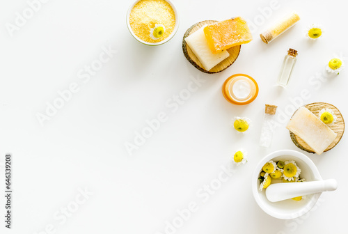Herbal organic cosmetics products with chamomile flowers, top view