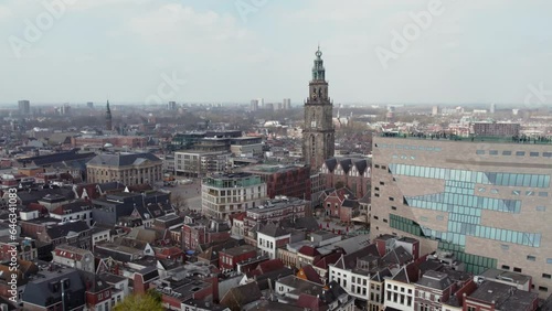 Forum Groningen Cultural Center With Martinitoren At Background In The City Center Of Groningen, Netherlands. Aerial Sideways Shot photo