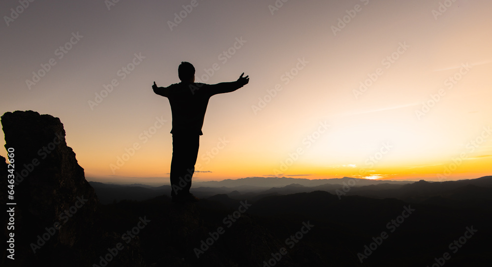 Human hands open palm up worship, Praying hands, Copy space of man rise hand up on top of mountain and sunset sky abstract background. Freedom and travel adventure concept.