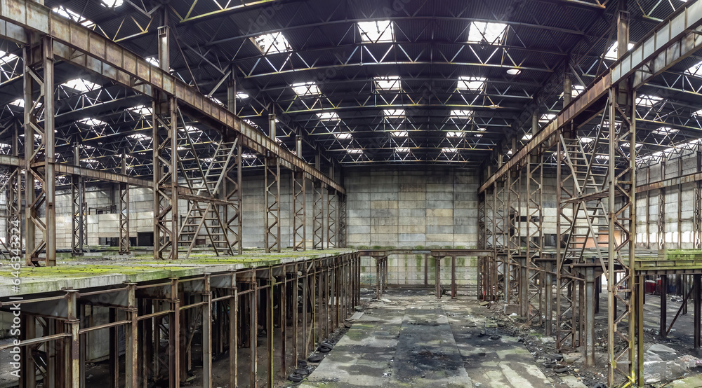 Neglected factory. Industrial building is empty. Supports inside hangar were rusted. Neglected building with traces of mold. Former factory after bankruptcy. Neglected industrial hangar Neglected factory. Industrial building is empty. Supports inside hangar were rusted. Neglected building with traces of mold. Former factory after bankruptcy. Neglected industrial hangar