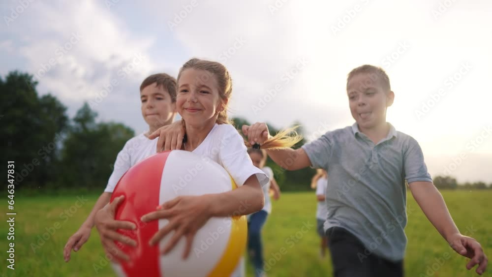 group of children run on the grass in the park with a ball. happy family childhood dream concept. kids run lifestyle around the meadow with grass and play inflatable ball together kids have fun group of children run on the grass in the park with a ball. happy family childhood dream concept. kids run lifestyle around the meadow with grass and play inflatable ball together kids have fun