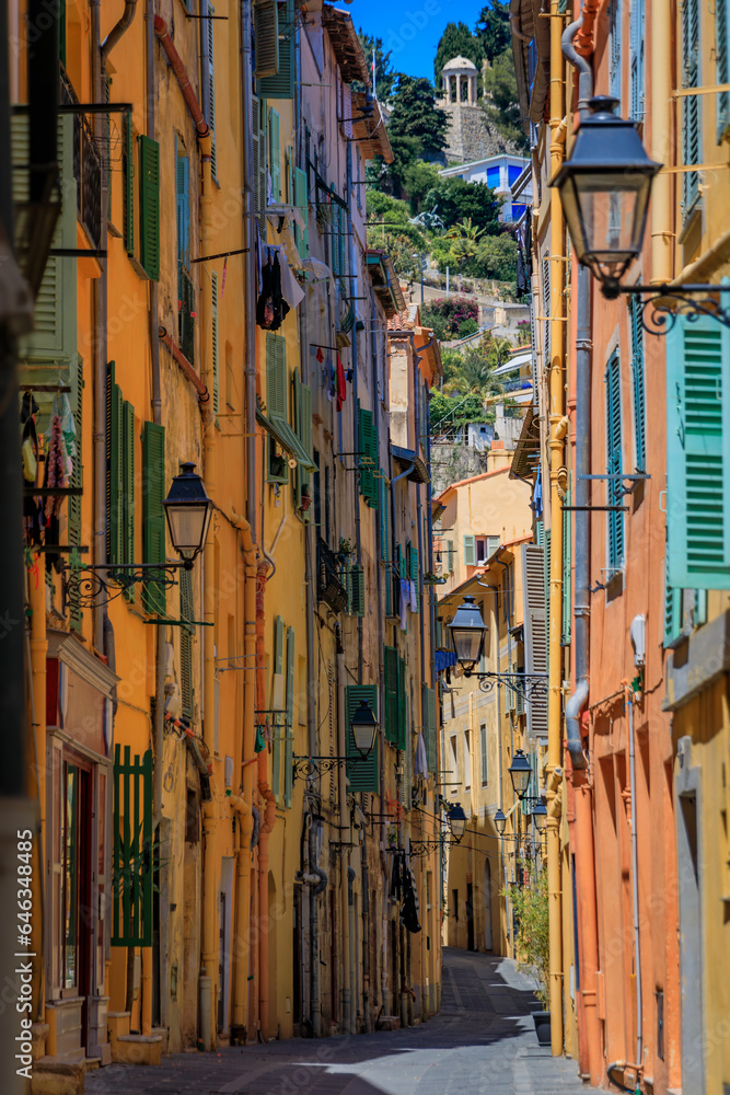 Picturesque narrow streets with colorful traditional houses in the old town of Menton, French Riviera, South of France