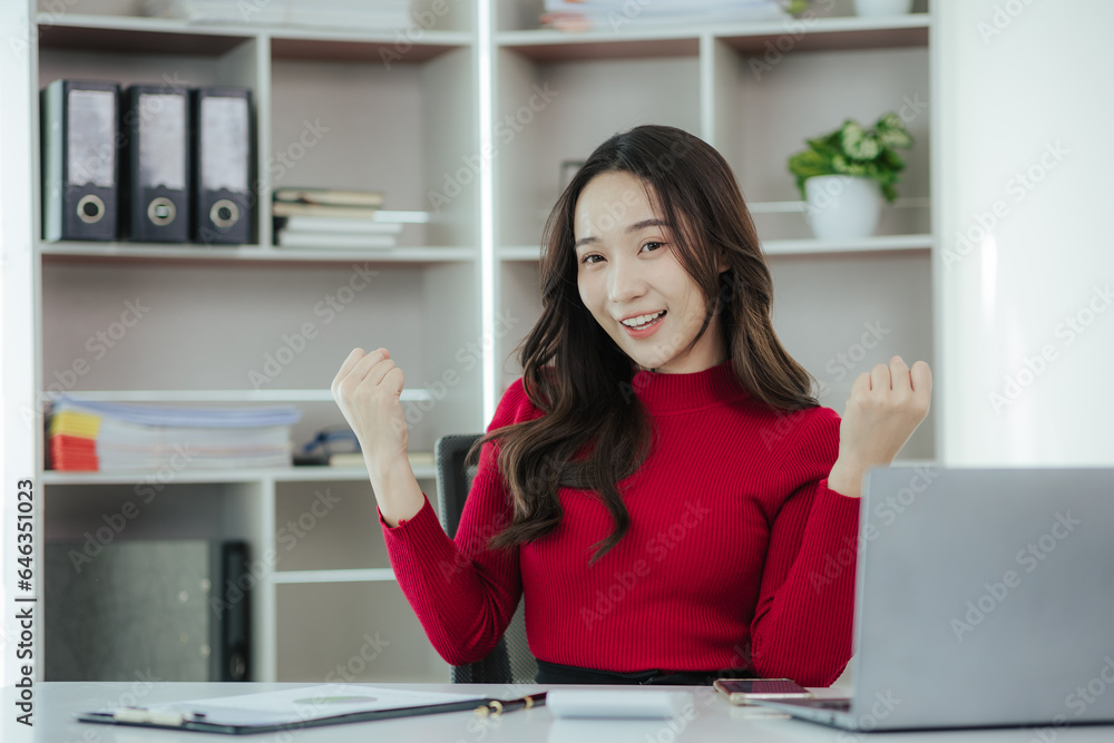 Beautiful Asian woman working on laptop in home office Beautiful Asian woman working on laptop in home office