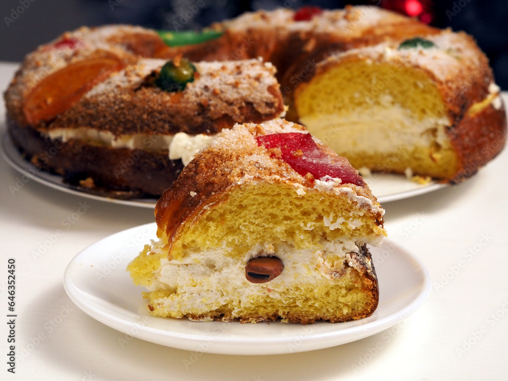 Close up of cake Roscon de Reyes with cream and a suprpise bean inside