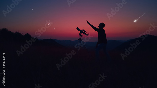 Astronomer looking at the stars, planets, Moon and celestial objects with a telescope.